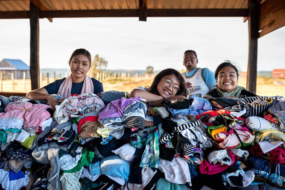 People sorting donated clothing together in a community setting
